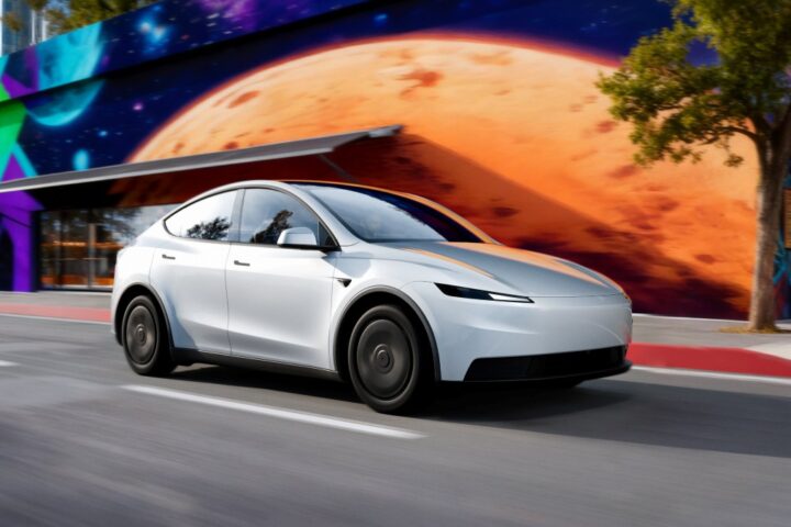 A white Tesla Model Y drives on a city street next to a colorful mural, with text overlay detailing features and pricing of the Model Y and Model 3 Standard models.