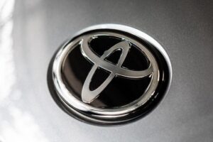 Close up of a silver Toyota emblem on the front of a vehicle