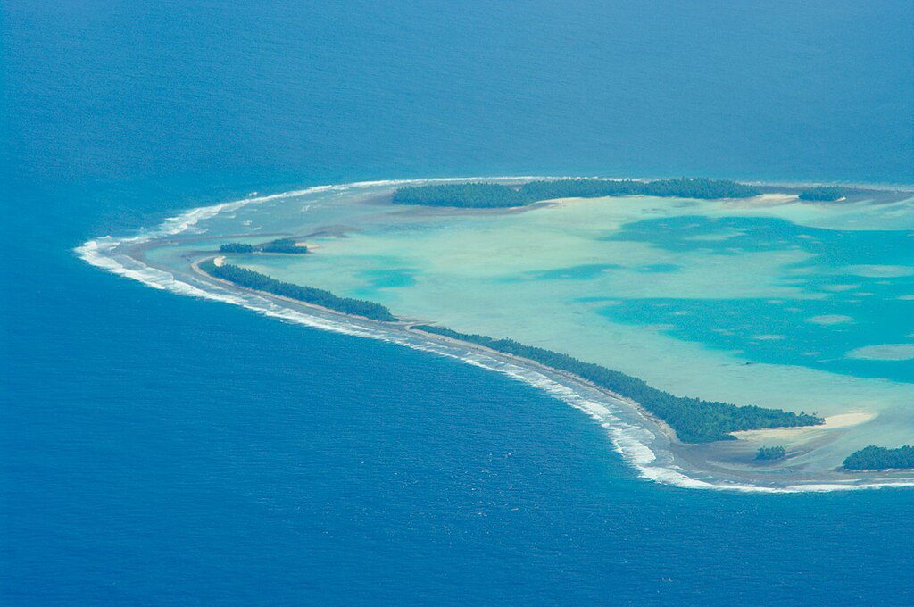 Aerial view of Tuvalu atoll with narrow land and surrounding ocean