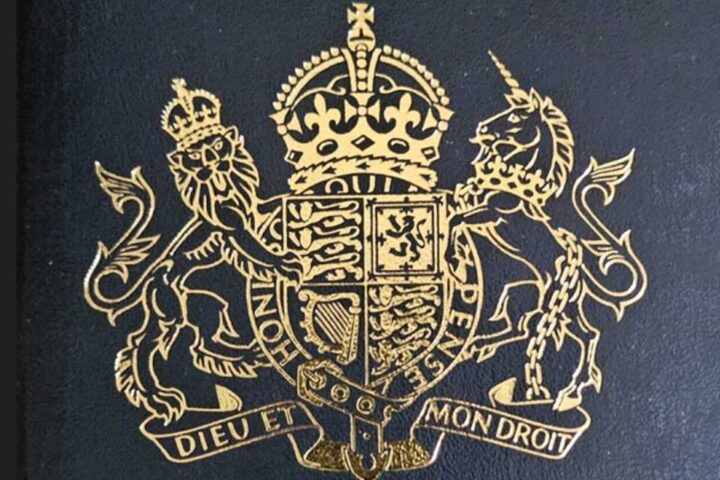 Gold-embossed Royal Coat of Arms on a dark-blue UK passport cover