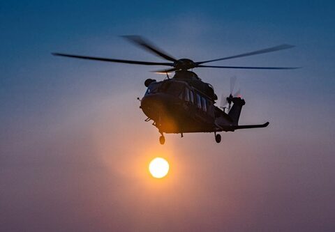 MH-139A Grey Wolf helicopter in early morning flight with rotor blur, credited to Boeing/Fred Troilo.