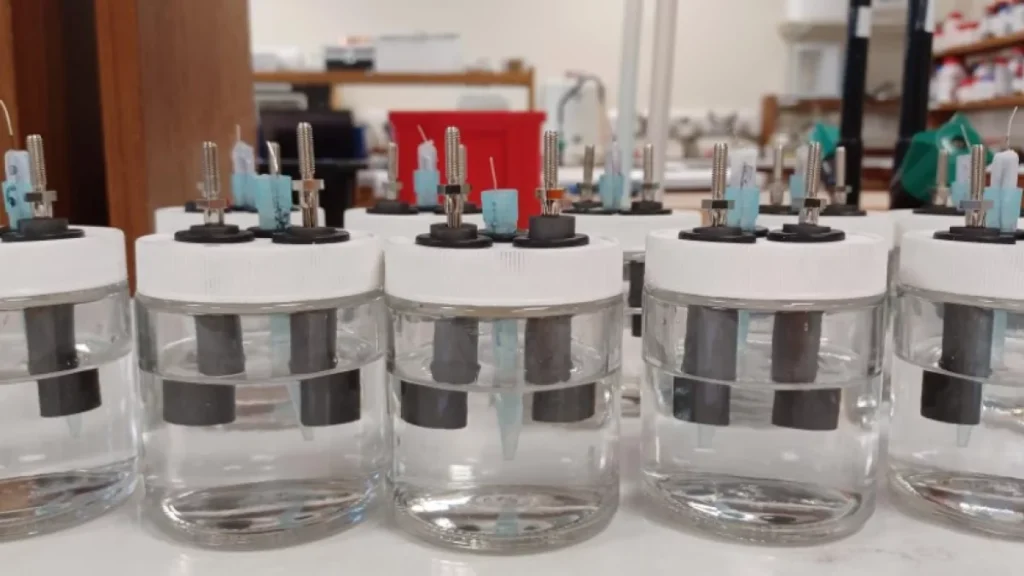 Sodium-ion battery graphic showing NVOH cathode performance and desalination test in saltwater.