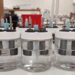 Sodium-ion battery graphic showing NVOH cathode performance and desalination test in saltwater.