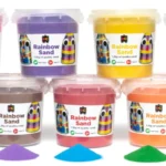 Recalled EC Rainbow Sand containers displayed in the ACCC safety notice following confirmed detection of tremolite asbestos in certain batches sold in Australia.