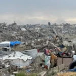 View of a heavily damaged street in central Gaza City showing collapsed façades and rubble-strewn pavement after February 2025 bombardment