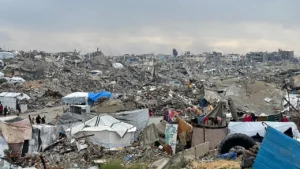 View of a heavily damaged street in central Gaza City showing collapsed façades and rubble-strewn pavement after February 2025 bombardment