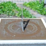 Close-up of a bronze horizontal sundial at Bruton Parish Church in Williamsburg, Virginia, used as the feature image for a daylight saving time explainer.