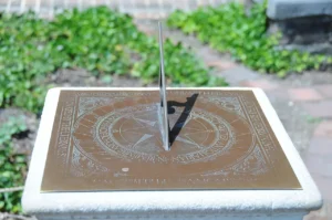 Close-up of a bronze horizontal sundial at Bruton Parish Church in Williamsburg, Virginia, used as the feature image for a daylight saving time explainer.