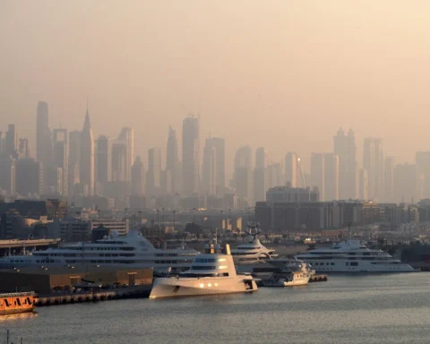 Cruise ships docked in Dubai with the skyline partially obscured by heavy haze caused by elevated air pollution.