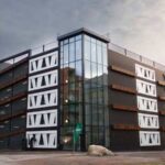 Exterior view of the Niels Bohr multi-storey car park in Brunnshög, Lund, featuring façade panels made from reused wind-turbine rotor blades.
