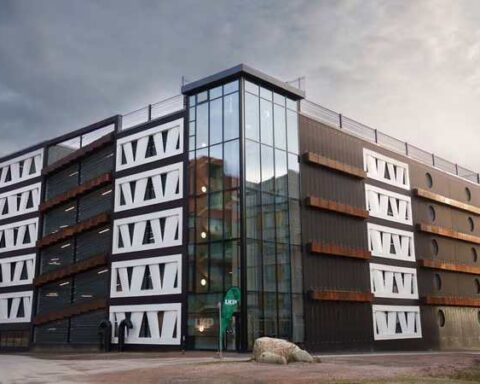 Exterior view of the Niels Bohr multi-storey car park in Brunnshög, Lund, featuring façade panels made from reused wind-turbine rotor blades.
