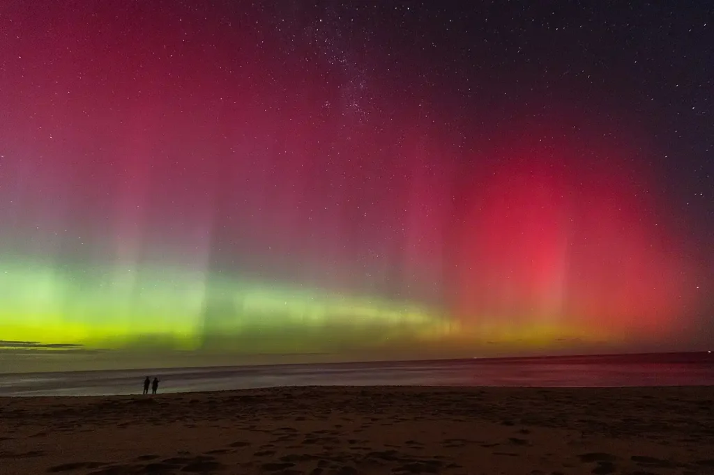 Aurora australis visible above Melbourne, Australia, during heightened geomagnetic activity caused by solar storms.
