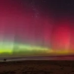 Aurora australis visible above Melbourne, Australia, during heightened geomagnetic activity caused by solar storms.
