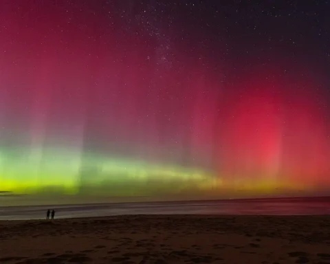 Aurora australis visible above Melbourne, Australia, during heightened geomagnetic activity caused by solar storms.