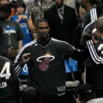 Chris Bosh in a Miami Heat warm-up suit fist-bumping teammates during pregame introductions in December 2012.