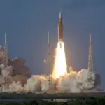 Artemis II Space Launch System rocket lifting off from Kennedy Space Center with the Orion spacecraft and crew aboard.