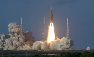 Artemis II Space Launch System rocket lifting off from Kennedy Space Center with the Orion spacecraft and crew aboard.