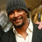 Damon Wayans Sr. smiling in a casual outfit, highlighting his role in raising awareness about diabetes-related vision loss and eye health