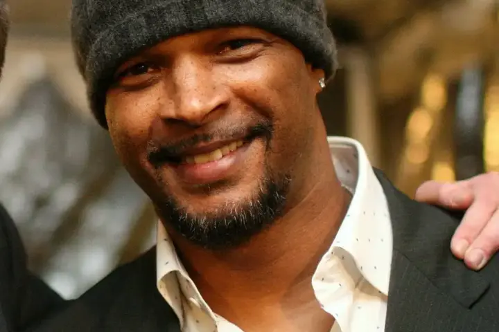 Damon Wayans Sr. smiling in a casual outfit, highlighting his role in raising awareness about diabetes-related vision loss and eye health