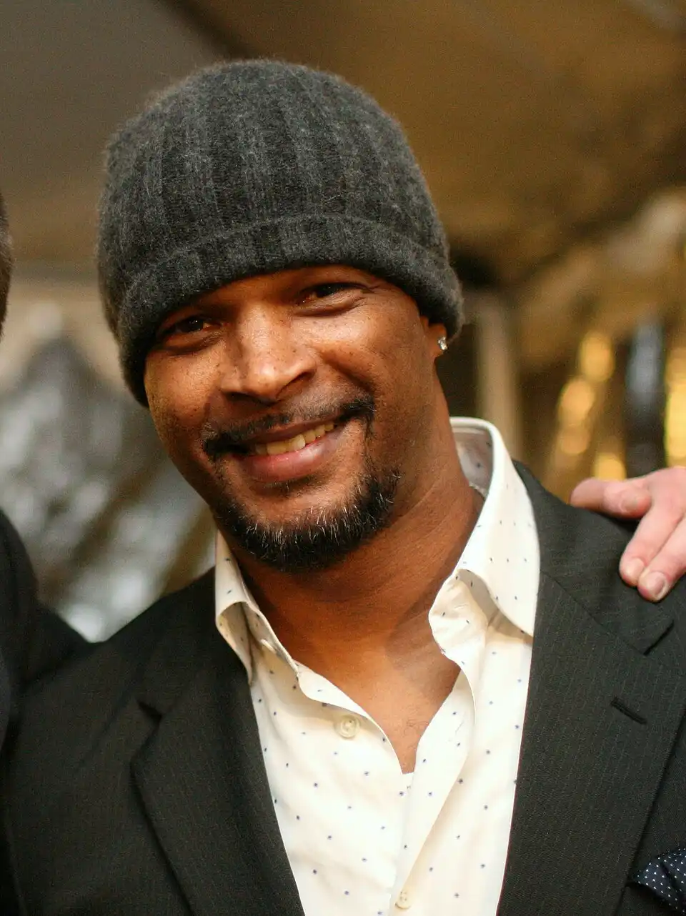 Damon Wayans Sr. smiling in a casual outfit, highlighting his role in raising awareness about diabetes-related vision loss and eye health