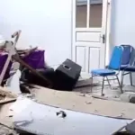 Interior damage with scattered debris and chairs after a strong earthquake in North Sulawesi following the Ternate offshore quake