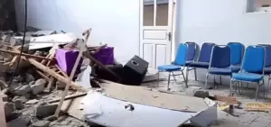Interior damage with scattered debris and chairs after a strong earthquake in North Sulawesi following the Ternate offshore quake