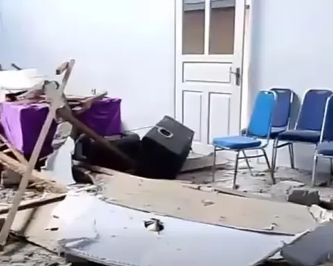 Interior damage with scattered debris and chairs after a strong earthquake in North Sulawesi following the Ternate offshore quake