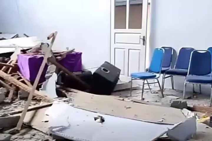 Interior damage with scattered debris and chairs after a strong earthquake in North Sulawesi following the Ternate offshore quake