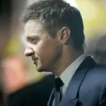 Jeremy Renner in profile at a red carpet event wearing a suit during The Bourne Legacy premiere in Sydney