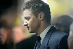 Jeremy Renner in profile at a red carpet event wearing a suit during The Bourne Legacy premiere in Sydney