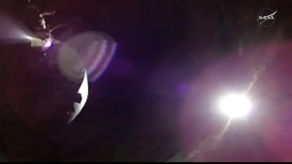 Artemis II Orion spacecraft observing a solar eclipse from behind the Moon, with the Sun’s corona visible in deep space