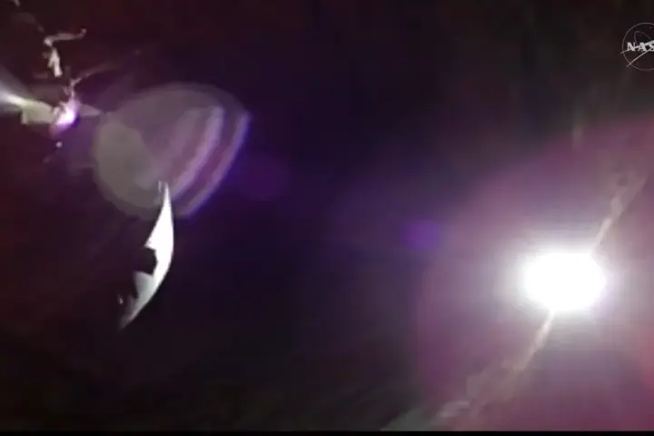 Artemis II Orion spacecraft observing a solar eclipse from behind the Moon, with the Sun’s corona visible in deep space