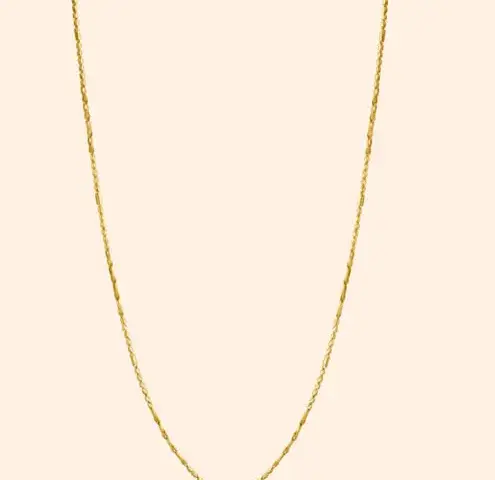 Delicate ladies' gold chain with a fine link pattern and polished gold finish displayed against a neutral background.