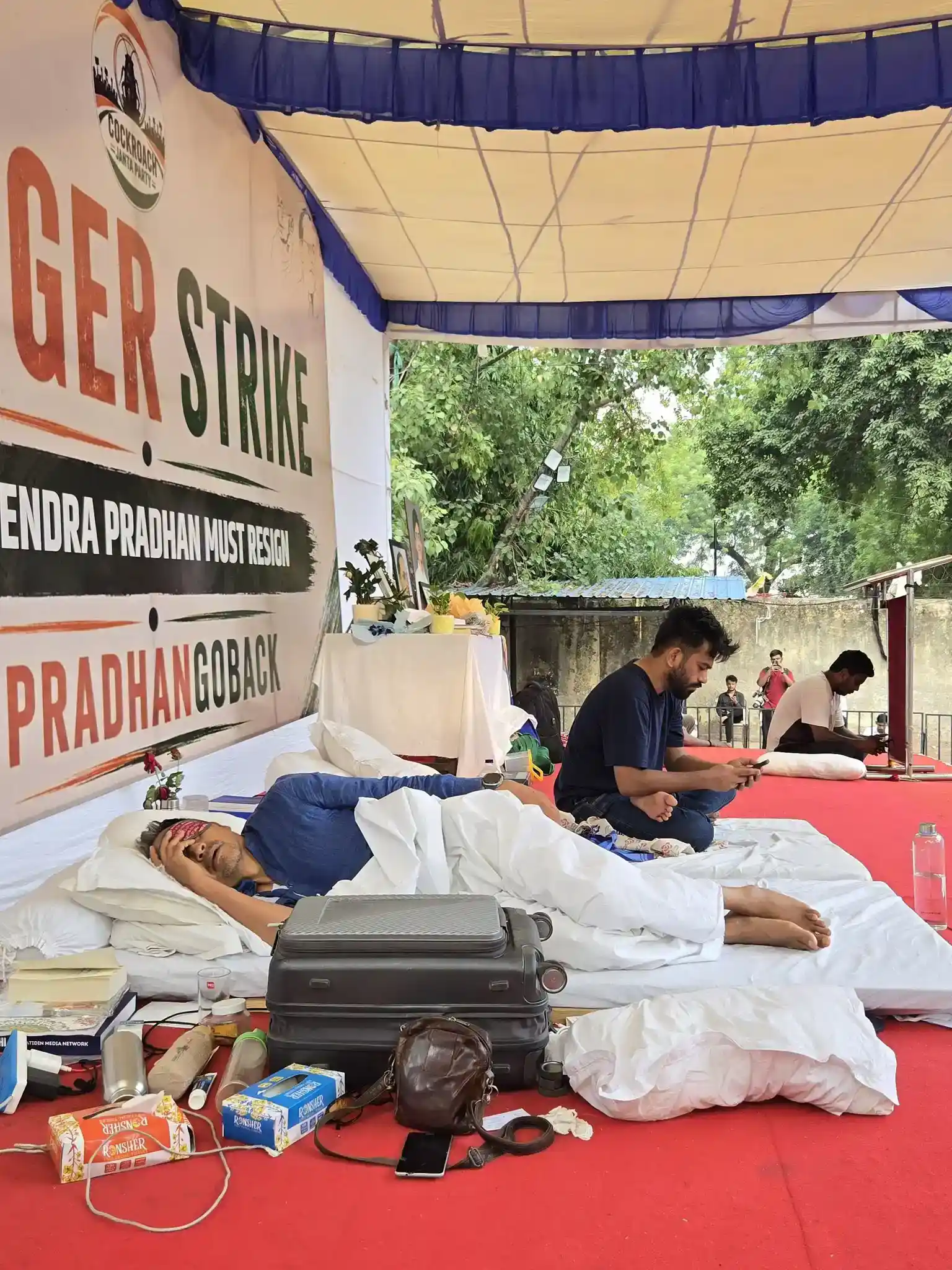 Abhijeet Dipke and Sonam Wangchuk sitting together at Jantar Mantar protest site in New Delhi during CJP student-led movement demonstration against NEET paper leak and government accountability, July 2026