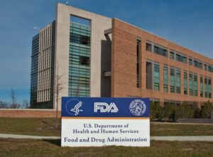 Exterior view of the FDA headquarters campus in Silver Spring, Maryland, featuring the agency's sign and Building 21 in the background.
