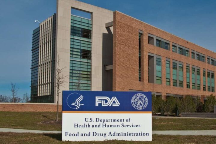 Exterior view of the FDA headquarters campus in Silver Spring, Maryland, featuring the agency's sign and Building 21 in the background.