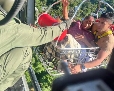 Indian Air Force personnel hoisting a flood-affected civilian from Brahmaputra valley terrain during July 2026 emergency rescue operations in Assam.