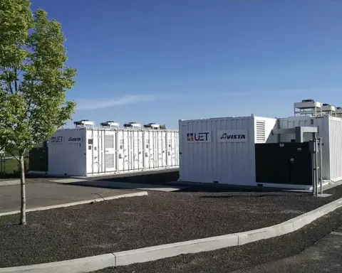 White containerised battery energy storage containers with UET and Avista branding, cooling units on roof.