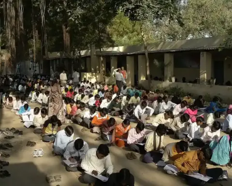 Students writing examinations in a hall in Jaura, India.