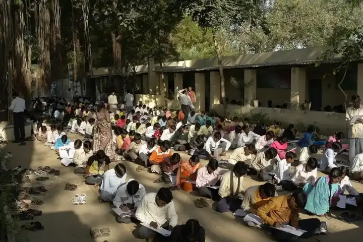Students writing examinations in a hall in Jaura, India.
