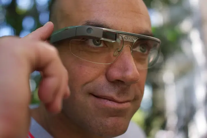 Person wearing Google Glass smart eyewear.