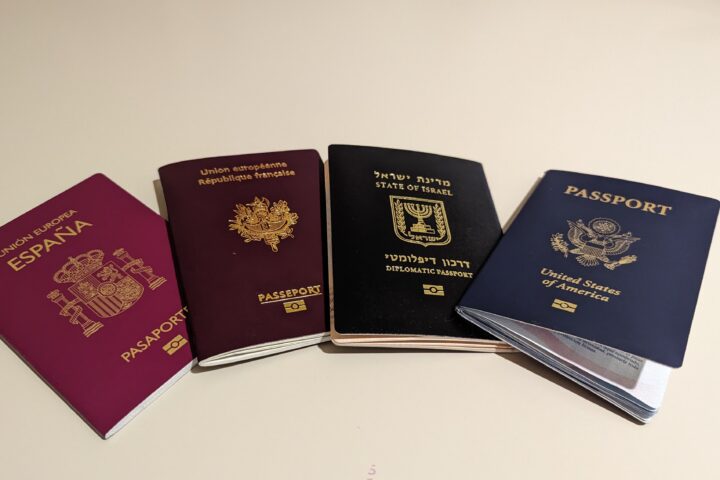 Four different national passports laid side by side showing varied covers and designs.