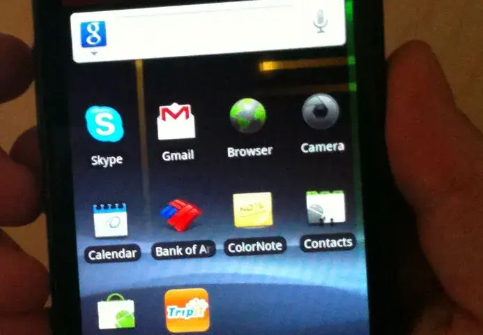 Google Nexus S smartphone held in a hand against a neutral background.