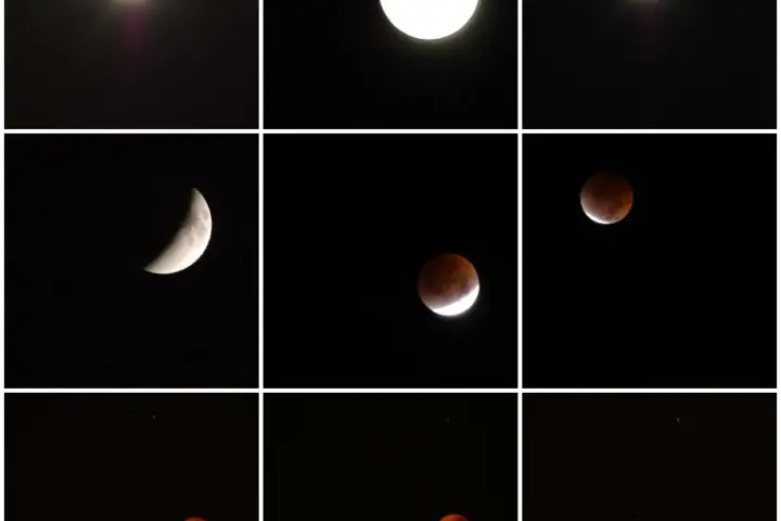 Partially eclipsed Moon glowing red-orange during a lunar eclipse.