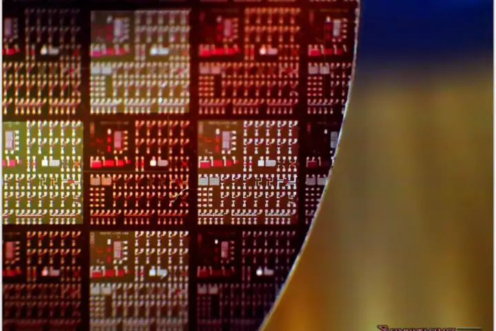 Macro photograph of a silicon semiconductor wafer covered in a dense grid of integrated circuit dies.