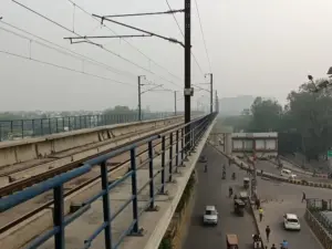 Elevated metro viaduct with safety railing at a Delhi Metro station in Noida