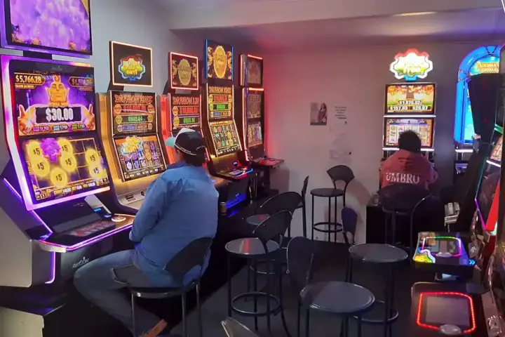 Rows of gaming slot machines inside a pokies room at an Australian hotel