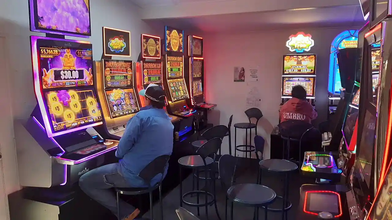 Rows of gaming slot machines inside a pokies room at an Australian hotel