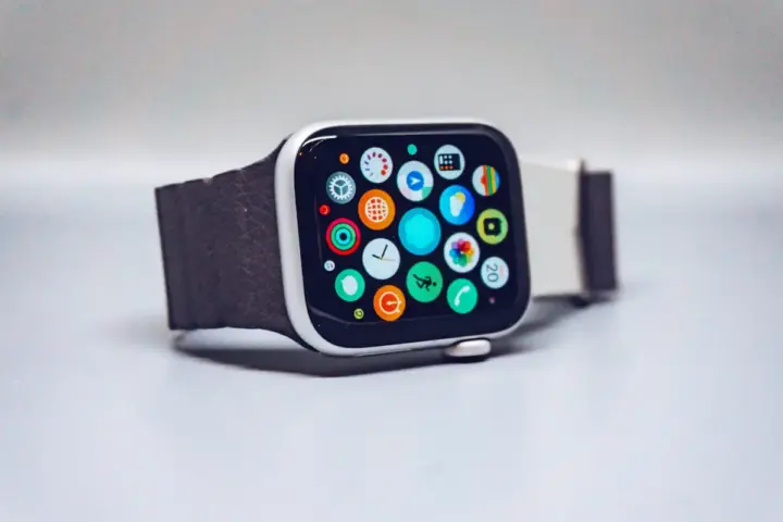 Close-up of black smartwatch displaying activity rings and fitness metrics