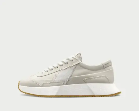 A compostable sneaker showcasing regenerative fashion design at a product awards event.
